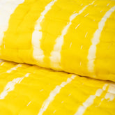 Handmade yellow tie-dye cotton Kantha quilt. Unique, vibrant & cozy. Perfect as a blanket, throw, or wall hanging. Shop now!